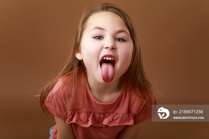 Portrait of preschool girl showing tongue