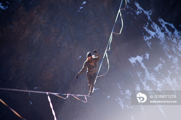 A daredevil balancing high over a lake on a beautiful winter day