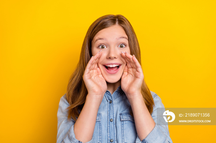 Photo of impressed small blond girl tell secret wear jeans shirt isolated on yellow color background