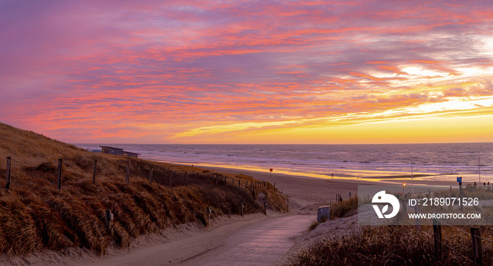 Beautiful panorama view of sunset from the sand dunes (dyke) at Dutch north sea coast, Amazing colou