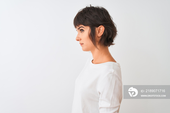 Young beautiful woman wearing casual t-shirt standing over isolated white background looking to side