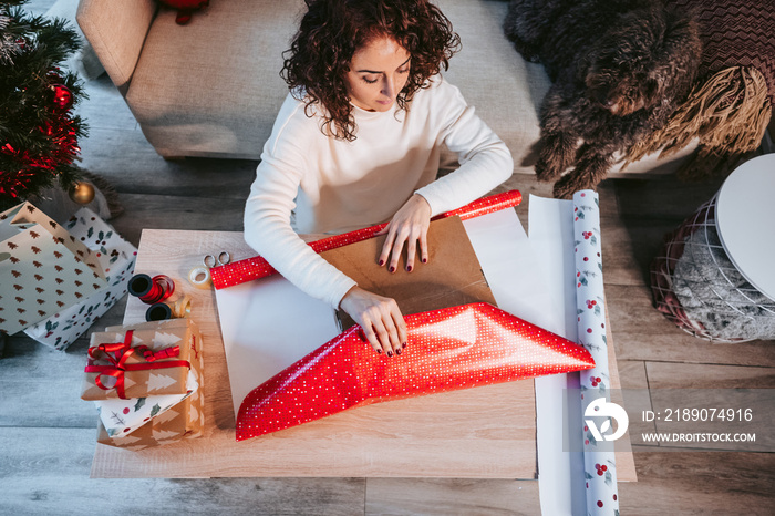 A woman wrapping presents with pets