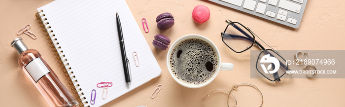 Cup of coffee with female accessories and office supplies on color background