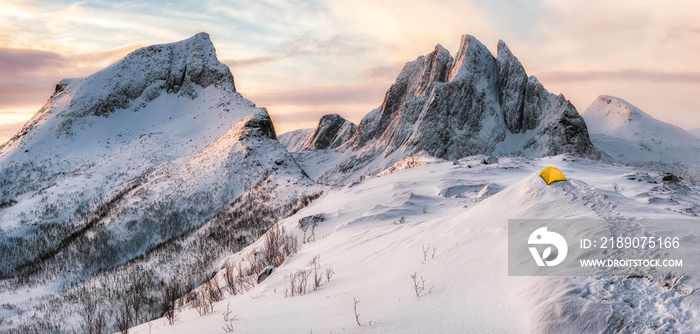 Panorama of Steep peak mountains with covered snow and yellow tent