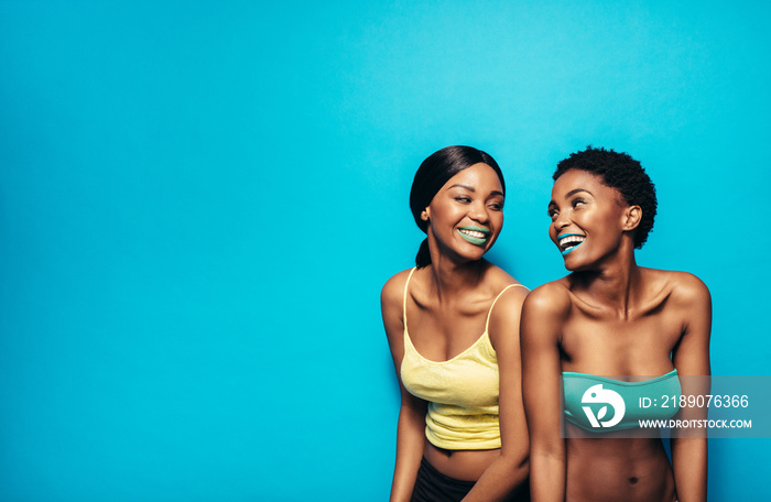 Two women standing together and smiling