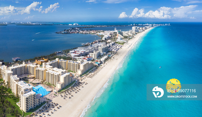 Cancun beach with para sailing over water