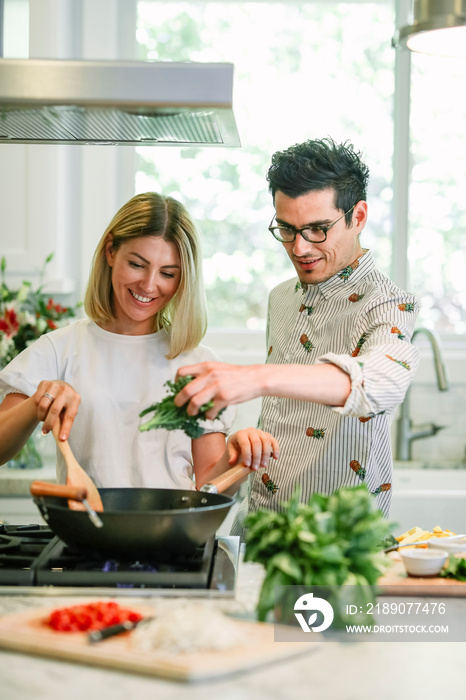 Happy couple cooking in the kitchen