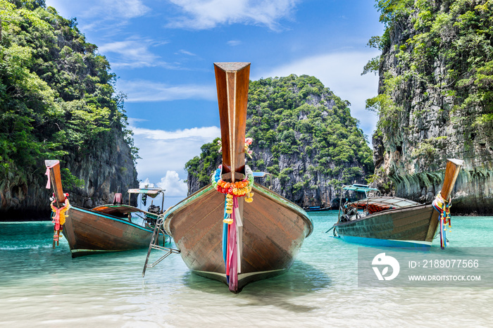 Thai traditional wooden longtail boat and beautiful beach in Thailand.