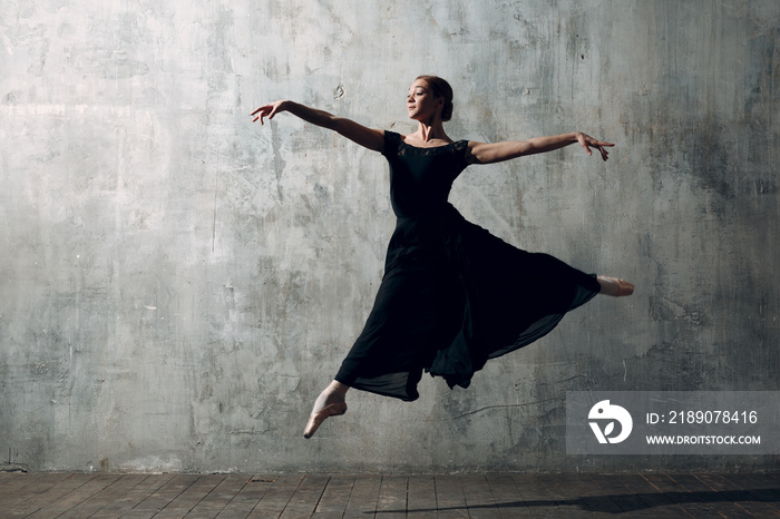 Ballerina female. Young beautiful woman ballet dancer, dressed in professional outfit, pointe shoes 