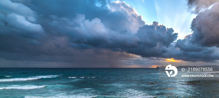 Dark clouds over Capo Caccia at sunset