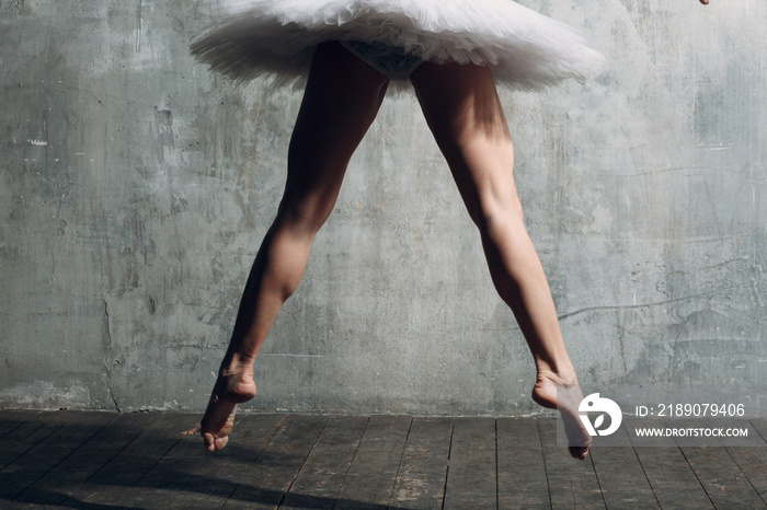 Ballerina slim legs. Young beautiful woman ballet dancer, dressed in professional outfit, pointe sho