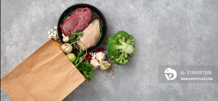 Shopping bag groceries with healthy food top view on a concrete background copy space