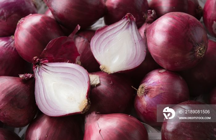 Fresh purple onions and one sliced onion