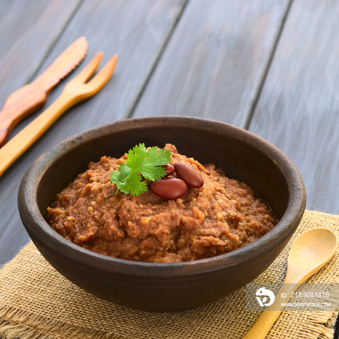 Homemade red kidney bean spread garnished with kidney beans and fresh coriander leaf, photographed o