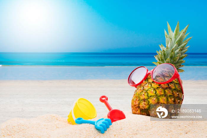 pineapple on the beach sunbathing, holidays and summer