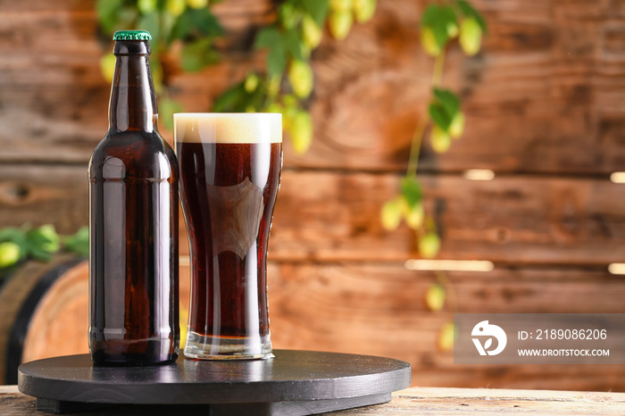 Glass and bottle of fresh beer on table