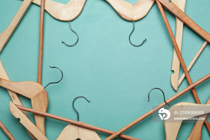 Clothes hangers on color background