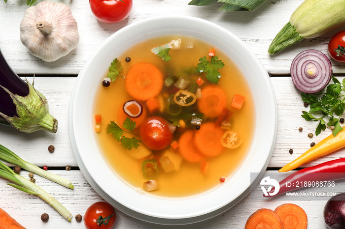 Soup and fresh vegetables on wooden background