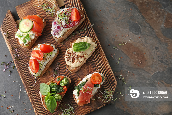 Fresh tasty bruschettas on wooden board