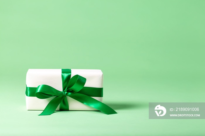 Handmade present box on a bright green background