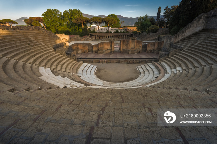 Ruins of amphitheatre at sunset, Pompeii, ancient roman city near Vesuvius volcano, Italy