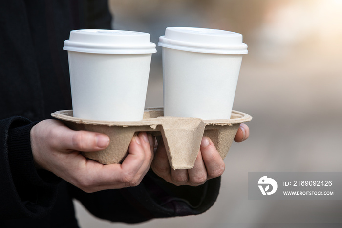 Paper coffee cups to take away. Early morning, breakfast and start of the working day