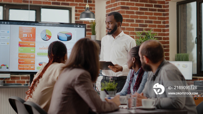 Business man with tablet presenting financial analysis with charts on monitor, planning project and 