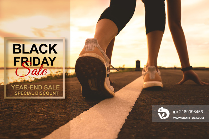 Black Friday Sale, sport runner start running on sunset - focus on shoe
