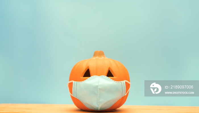 October break pumpkin.Halloween facial mask as a jack o lantern pumpkin wearing a medical face mask 