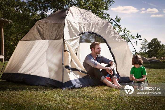 Father sitting with his boy (4-5) in backyard