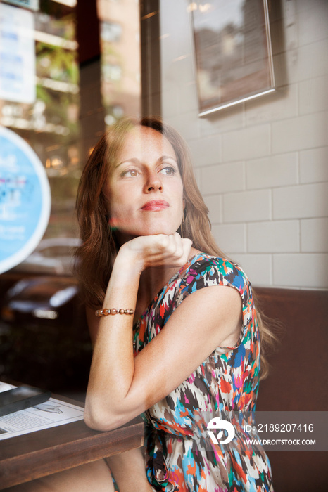 Woman looking through window