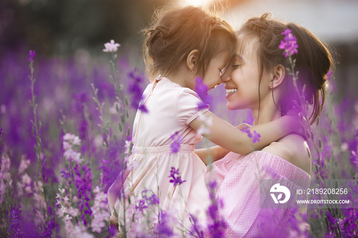 Very beautiful picture of young mother and child in the flower field