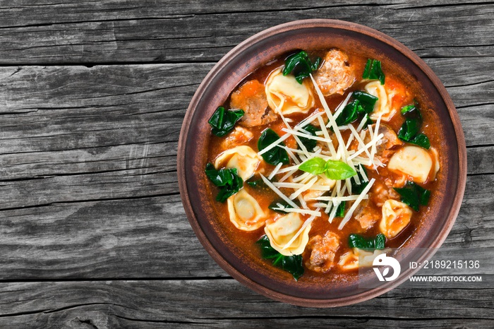 tortellini soup with italian sausages, spinach, tomato, parmesan cheese , top-view