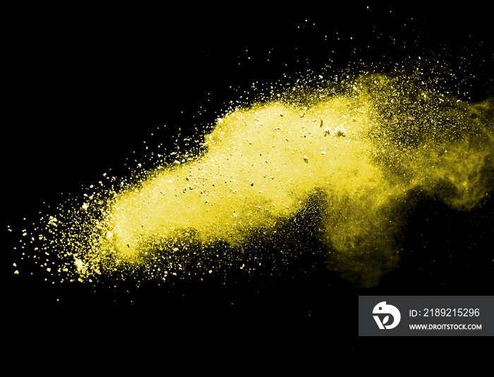 Yellow powder explosion on black background..