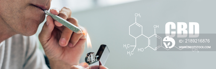 一名男子用医用大麻点燃钝器的裁剪图，cbd分子插图全景拍摄