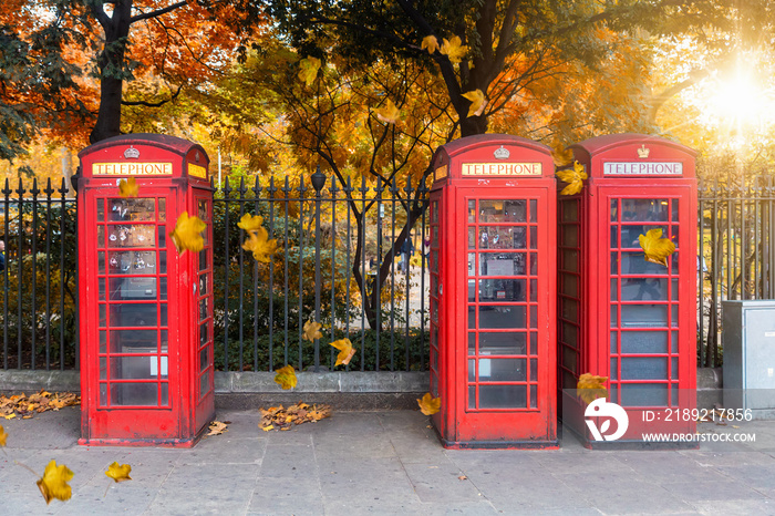 Klassisch，死记硬背的Telefonzellen aufgereiht vor einem Park im Herbst in London