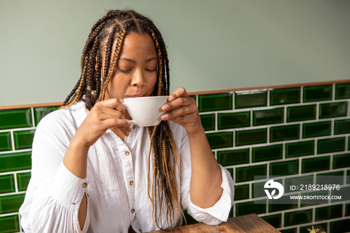 UK, London, Woman drinking coffee at cafe table