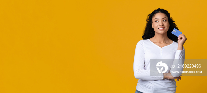 Ready For Shopping.Portrait of dreamy african american female holding credit card