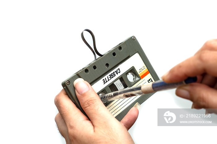 women rewind a cassette tape Vintage compact cassette on white background, Close up set of old audio