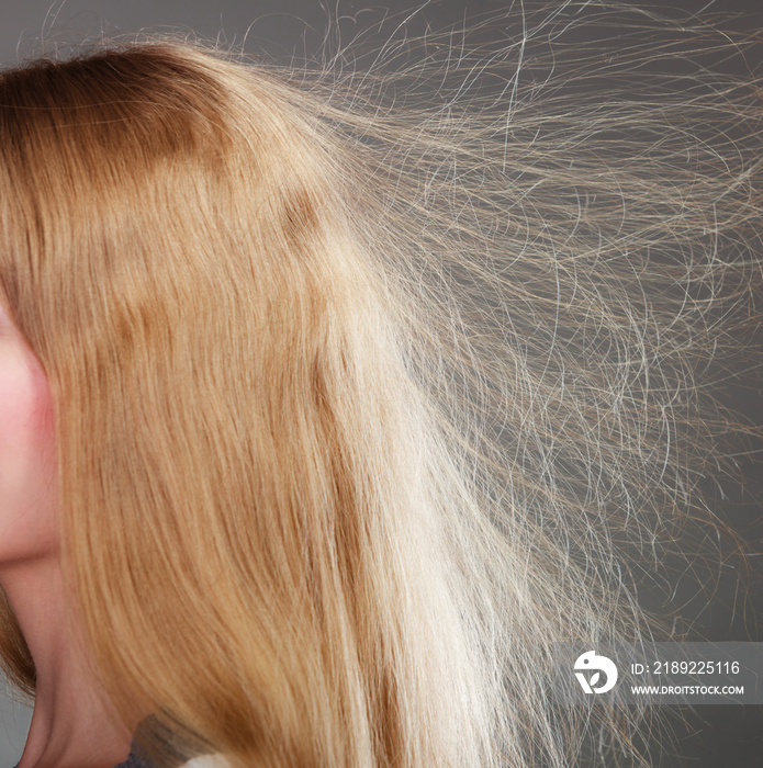 Closeup of woman with static blonde hair.