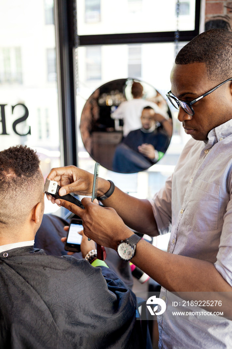 Barber cutting customers hair