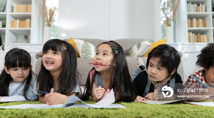 Group of little preschool kids drawing paper with color pencils . portrait of children friends educa