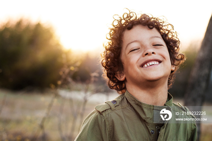 Portrait of boy (6-7) smiling in meadow