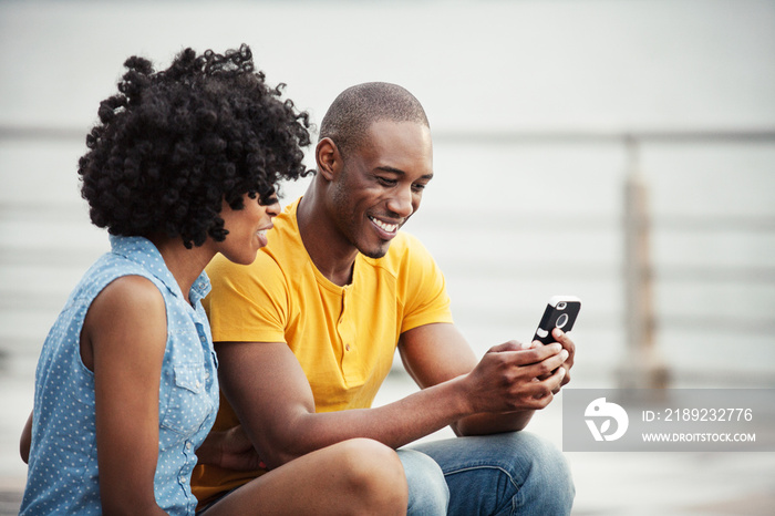 Couple texting on promenade