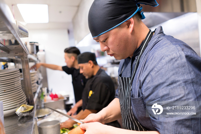 Chefs in kitchen preparing food