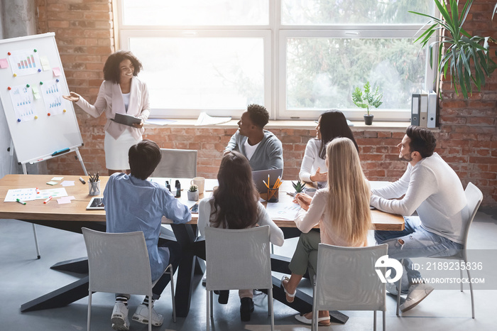 Black employee making presentation during morning briefing