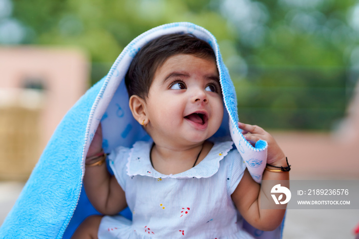 Indian baby girl child playing and giving smile