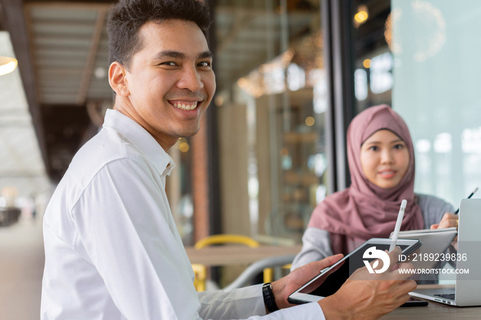 close up group of asian muslim young student man and woman studying together at outside library for 