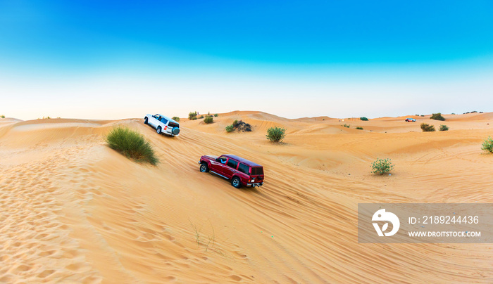 Jeep safari  over sand dunes in Dubai Desert Conservation Reserve, United Arab Emirates. Copy space 