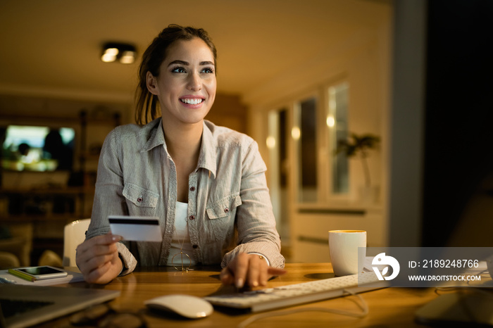 Smiling woman enjoying in online shopping in the evening at home.